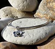 Sterling silver hammered oval bangle with sterling silver flower