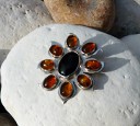Sterling silver sunflower brooch with onyx and amber